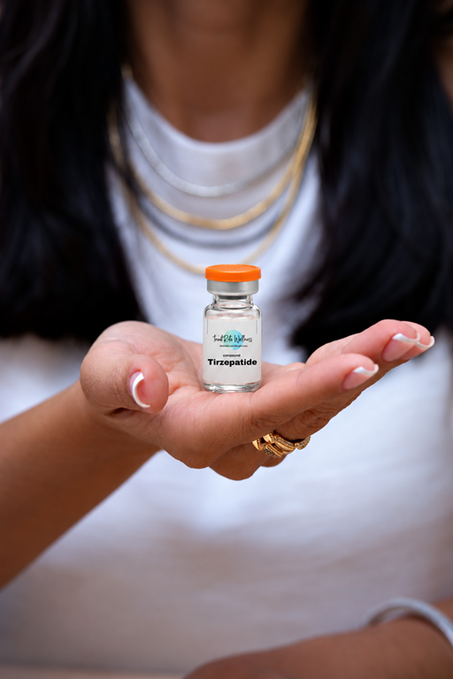 Tirzepatide vial held in an open palm, illustrating emerging weight-loss medications and future clinical trial treatments.